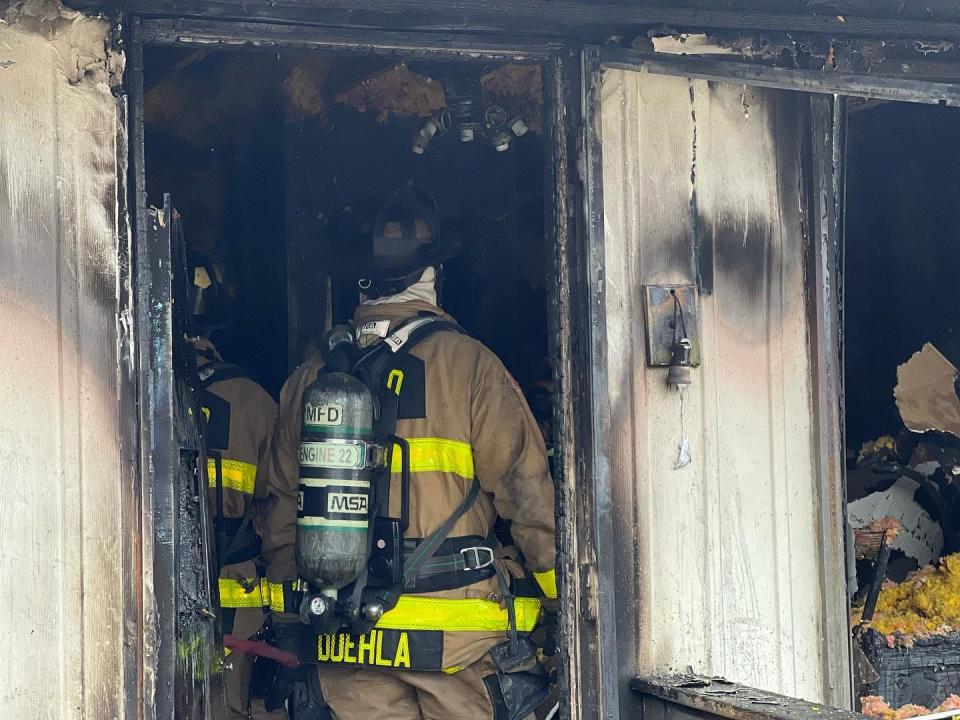 A firefighter with Monroe Fire Protection District works a fire in the 3100 block of Fairington Drive Thursday, March 29, 2023.