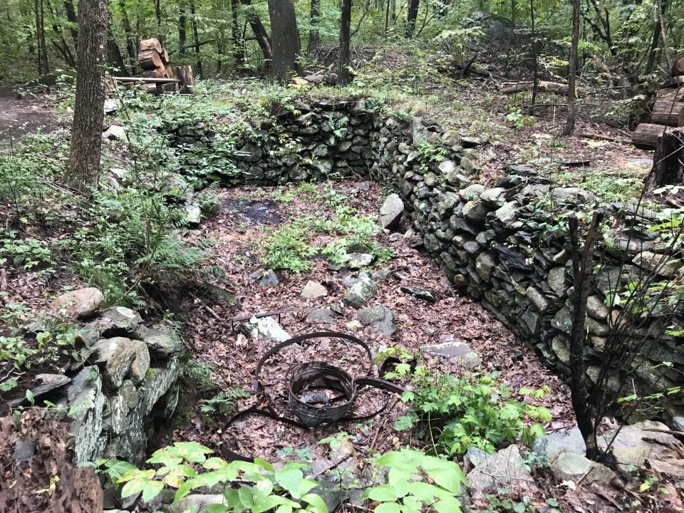 Just off the red-blazed trail, a cellar hole once supported a house where workers lived and harvested trees to heat a nearby “poorman’s” house.