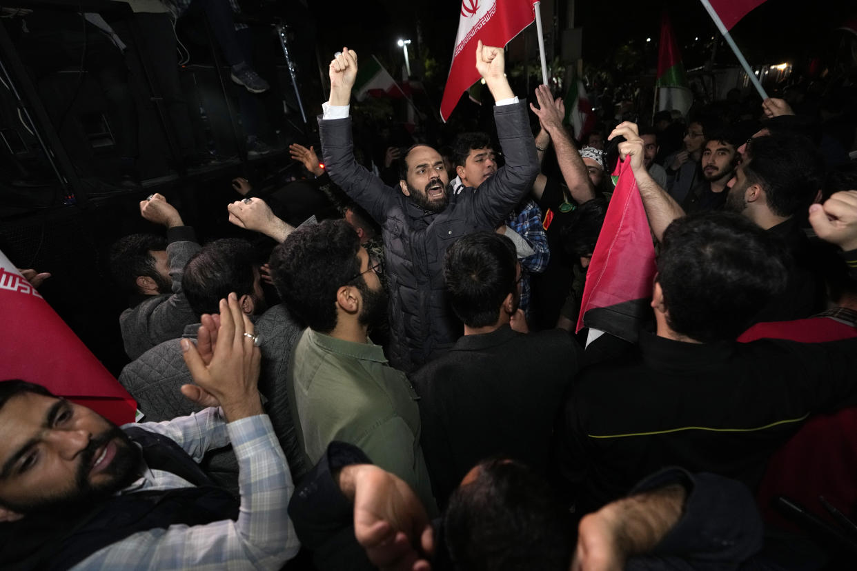 Iranian demonstrators chant slogans during an anti-Israeli gathering in front of the British Embassy in Tehran, Iran, early Sunday, April 14, 2024. Iran launched its first direct military attack against Israel on Saturday. (AP Photo/Vahid Salemi)