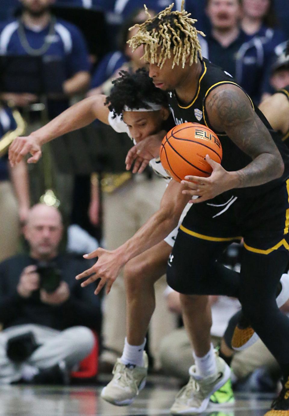 Akron's Enrique Freeman tries to steal the ball from Kent State's VonCameron Davis at Rhodes Arena on Friday.