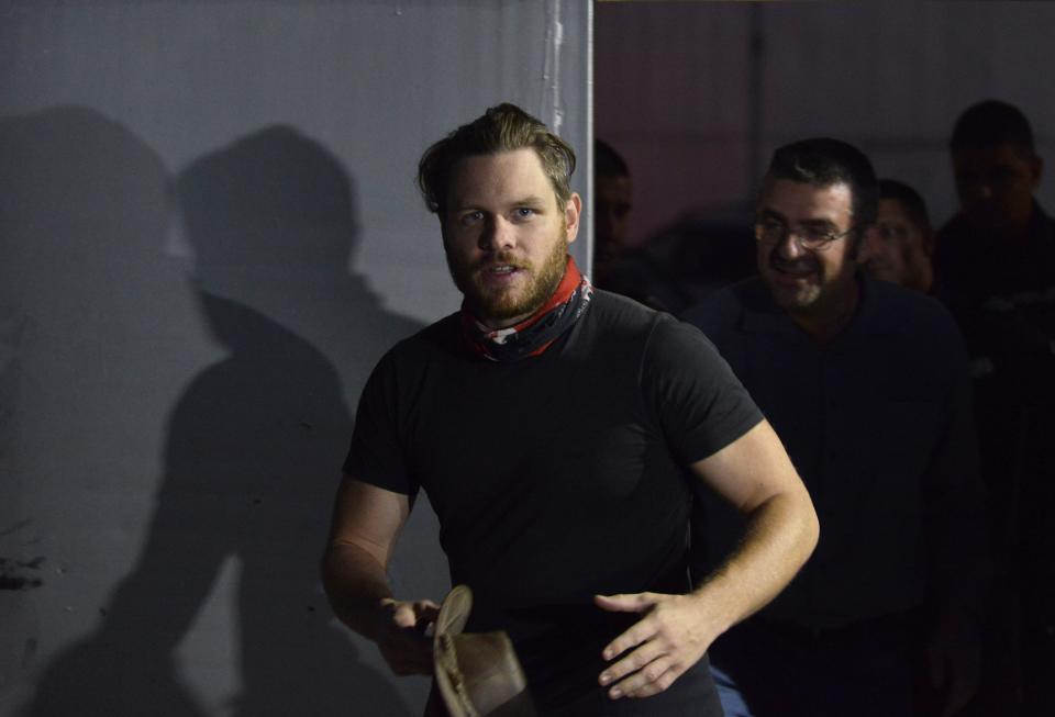 Jock Palfreeman reacts as he leaves migrants' detention centre in Busmantsi, Bulgaria, Tuesday, Oct. 15, 2019. Australian man Palfreeman was convicted of fatally stabbing a Bulgarian student during a 2007 brawl and has been paroled after serving 11-years of his 20-year prison sentence, but then held back in a detention centre after a prosecutors' petition to revoke the parole. (AP Photo)