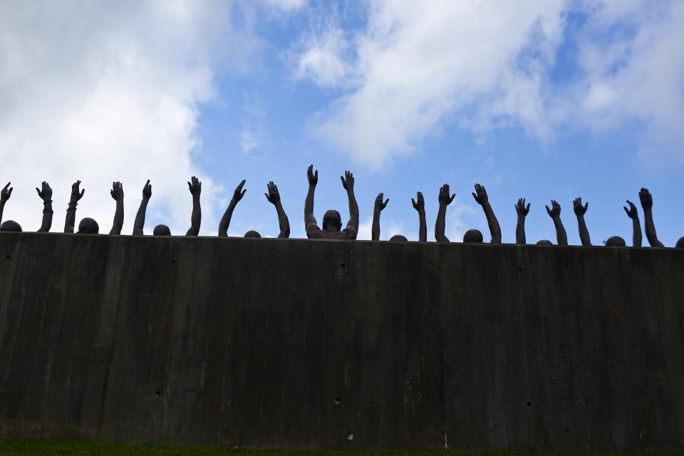 FILE - In this April 23, 2018, file photo, is a bronze statue called "Raise Up" that is part of the display at the National Memorial for Peace and Justice, a new memorial to honor thousands of people killed in racist lynchings in Montgomery, Ala. Some states have already criminalized the display of nooses, including Louisiana, Virginia, California, New York and Connecticut. Oregon's bill, if passed by the Democrat-controlled Legislature and signed by the Democratic governor, will make intimidation by display of a noose a misdemeanor punishable by up to a year in prison and a $6,250 fine. (AP Photo/Brynn Anderson, File)