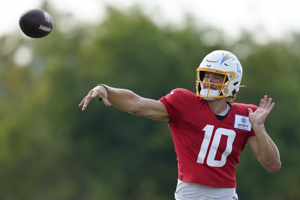 Los Angeles Chargers quarterback Justin Herbert (10) participates in drills at the NFL football team's practice facility in Costa Mesa, Calif. Monday, Aug. 1, 2022. (AP Photo/Ashley Landis)