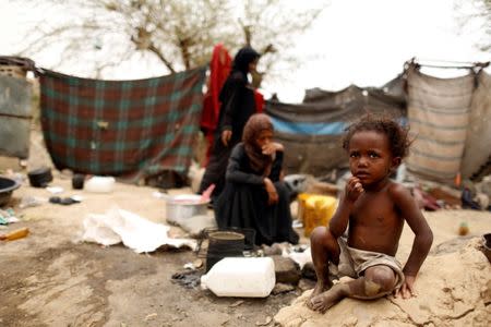 A boy displaced from the Red Sea port city of Hodeidah sits outside a house where he and his family live in the outskirts of Sanaa, Yemen July 10, 2018. REUTERS/Khaled Abdullah