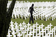 <p>A performer depicting death walks among tombstones at the French National Cemetery outside the Douaumont Necropolis and Ossuary, France, May 29, 2016, during a ceremony marking the 100th anniversary of the battle of Verdun, one of the largest battles of the First World War on the Western Front. <em>(Reuters/Philippe Wojazer)</em> </p>