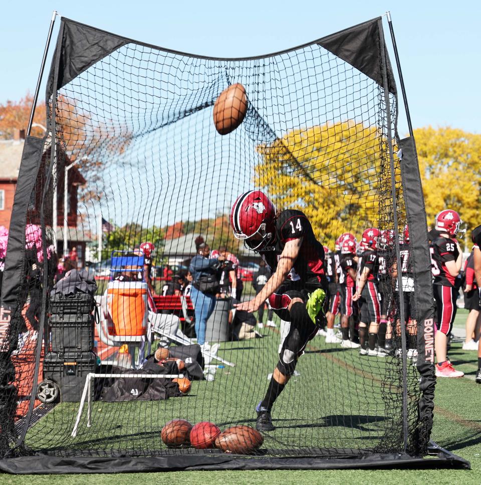 Brockton kicker John Dumas warms up on the sidelines  during a game versus Pinkerton Academy on Saturday, Oct. 15, 2022.
