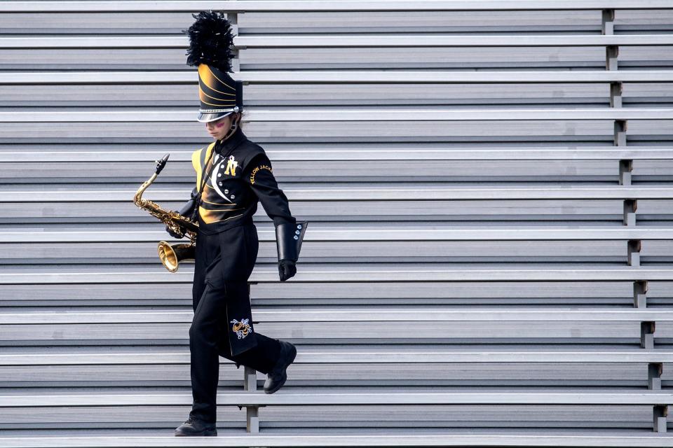 A member of the Newark Marching Band exits the bleacher area at the start of the Newark Yellow Jackets vs. the Lake Forest Spartans high school football game at Newark, Saturday, Oct. 8, 2022. Lake Forest won 53-24.