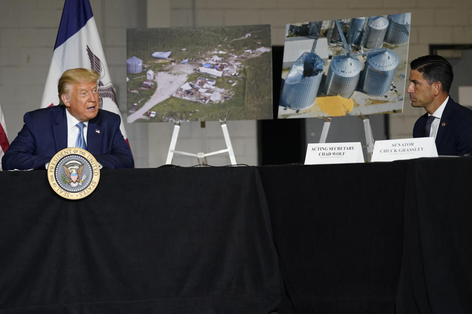 CORRECTS FROM FLOOD DAMAGE TO DERECHO DAMAGE - Department of Homeland Security Acting Secretary Chad Wolf, right, listens as President Donald Trump speaks during a briefing on derecho damage and recovery efforts in Iowa, Tuesday, Aug. 18, 2020, in Cedar Rapids, Iowa. (AP Photo/Evan Vucci)