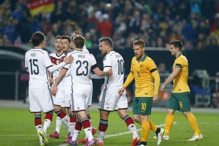 Germany's Lukas Podolski (C) celebrates with his team mates after scoring a goal against Australia during their international friendly soccer match in Kaiserslautern March 25, 2015. REUTERS/Ralph Orlowski