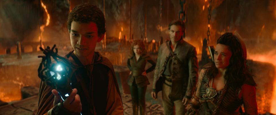 Simon (Justice Smith, from left) utilizes a magical artifact as Doric (Sophia Lillis), Edgin (Chris Pine) and Holga (Michelle Rodriguez) look on in "Dungeons & Dragons: Honor Among Thieves."