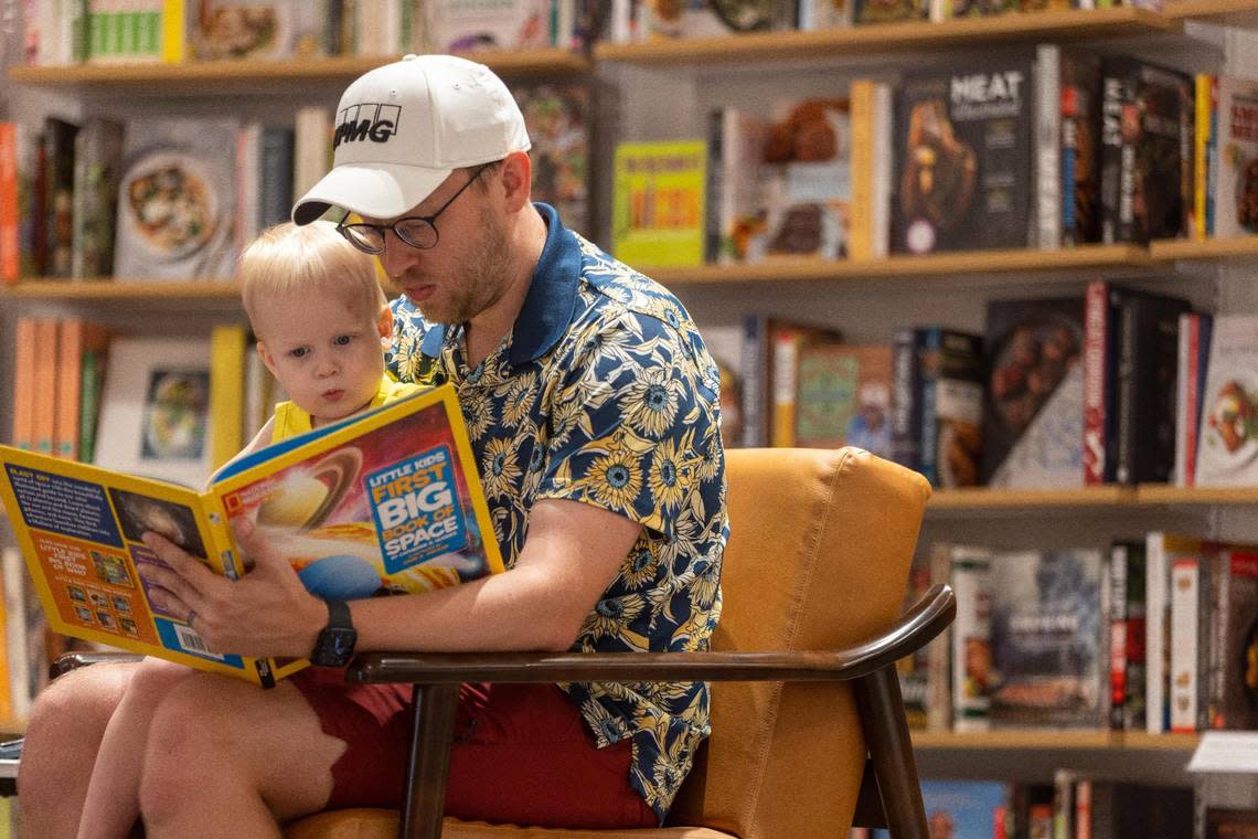 Cory Wills reads to two-year-old Ezra Wills at the new Barnes & Noble store which opened in the Shoppes of Kildare at 1311 Kildaire Farm Road on Wednesday, July 5, 2023 in Cary, N.C