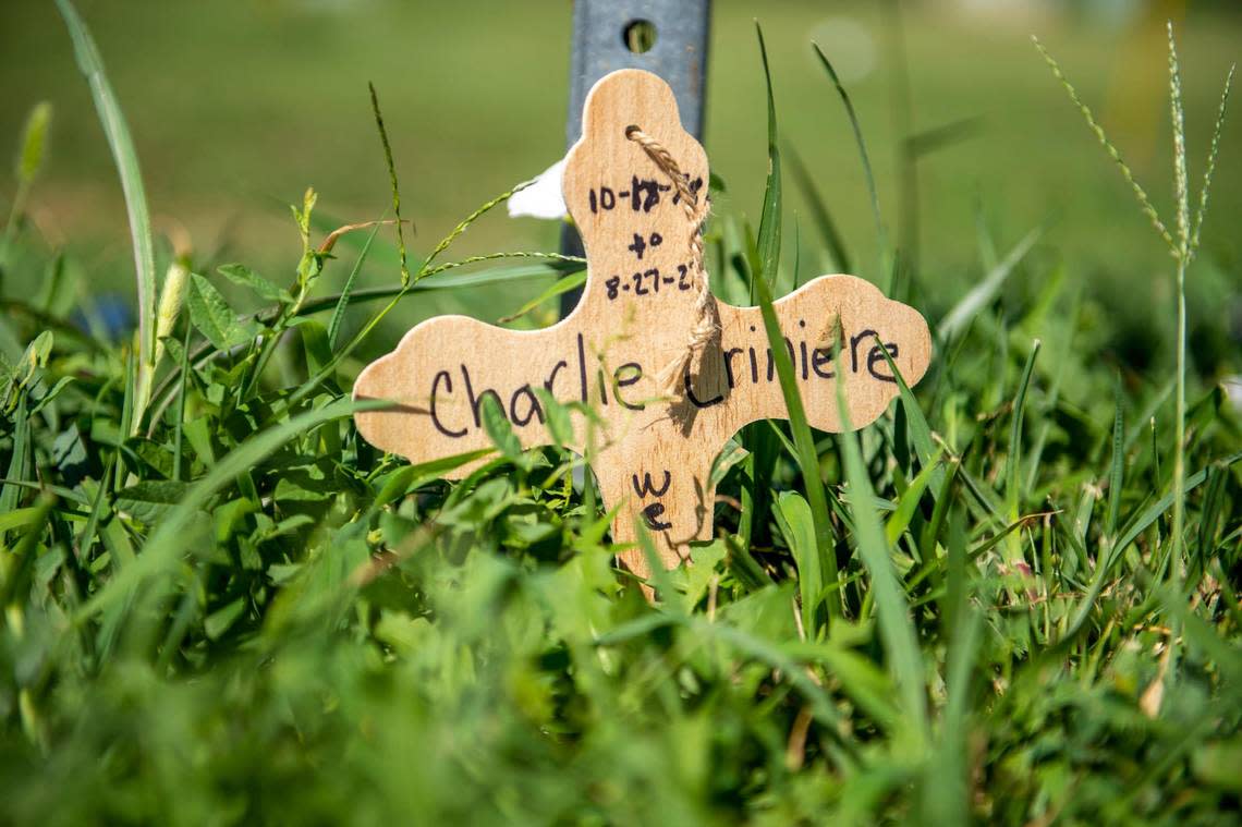 On Tuesday, Aug. 30, 2022, a small wooden cross could be seen next to a sign post as a memorial at the corner of View High Drive and Longview Road bicyclist Charles Criniere who was killed there Saturday by a hit and run driver. Emily Curiel/ecuriel@kcstar.com