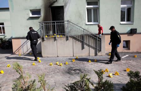 Police inspect the front of a mosque in Dresden, Germany on September 27, 2016, one day after an improvised bomb destroyed the entrance. REUTERS/Matthias Schumann