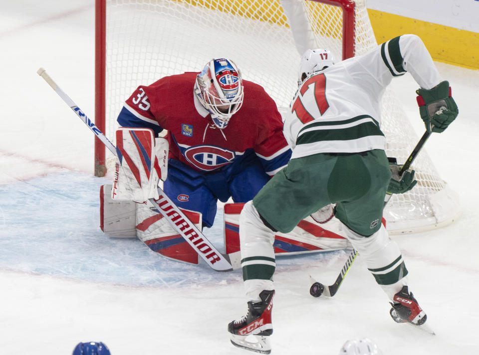Montreal Canadiens goaltender Sam Montembeault makes a save against Minnesota Wild's Marcus Foligno (17) during the first period of an NHL hockey game, Tuesday, Oct. 17, 2023 in Montreal. (Christinne Muschi/The Canadian Press via AP)