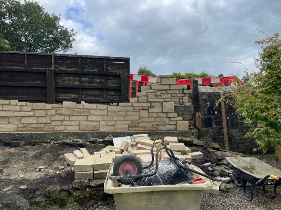 Council bosses told Bear Mason that someone had complained about the sandstone wall and that he needs to tear it down. (SWNS)