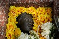 Flowers are placed over a monument to remember the victims of the massacre of pro-democracy students by state forces at Thammasat University on its 44th anniversary, in Bangkok