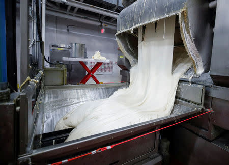 Freshly made dough comes out of a mixer during the production process at the Gonnella Baking Company in Aurora, Illinois, U.S., November 16, 2017. Picture taken November 16, 2017. REUTERS/Kamil Krzaczynski