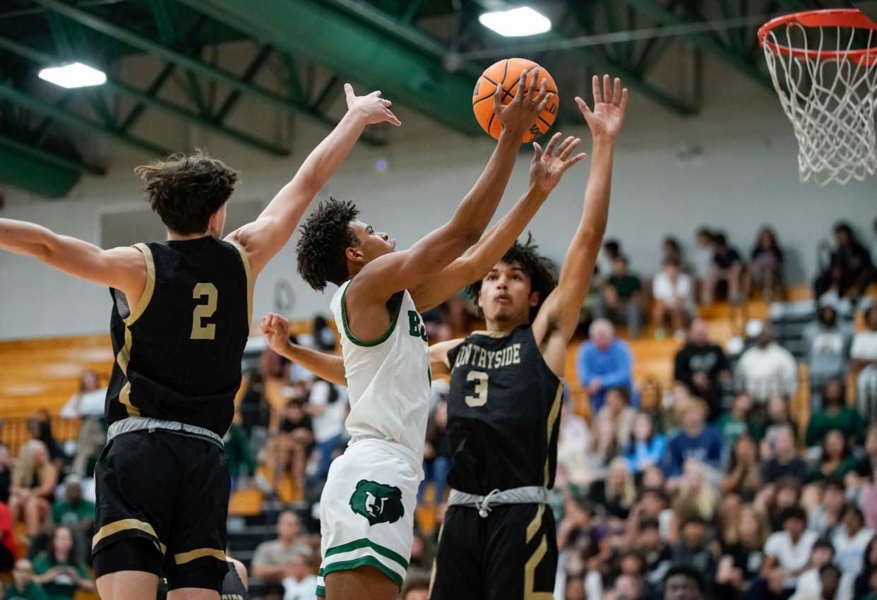 Palmetto Ridge Bears guard Iago Stanback (0) goes for a lay up while being guarded by Countryside Cougars guard Kobie White (3) during the third quarter of the Class 6A regional quarterfinal at Palmetto Ridge High School in Naples on Thursday, Feb. 16, 2023. 