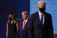 first lady Melania Trump, left, and President Donald Trump, center, remain on stage as Democratic presidential candidate former Vice President Joe Biden, right, walk away at the conclusion of the second and final presidential debate Thursday, Oct. 22, 2020, at Belmont University in Nashville, Tenn. (AP Photo/Julio Cortez)