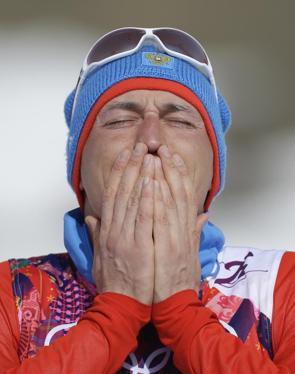 Russia's gold medal winner Alexander Legkov reacts during the flower ceremony of the men's 50K cross-country race at the 2014 Winter Olympics, Sunday, Feb. 23, 2014, in Krasnaya Polyana, Russia. (AP Photo/Gregorio Borgia)