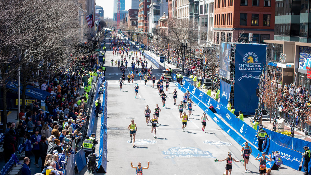  Runners approach the 2022 Boston Marathon finish line along the wide and straight Boylston Street. 