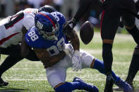 New York Giants tight end Evan Engram (88) fumbles before Atlanta Falcons cornerback Isaiah Oliver, right, recovers the ball during the first half of an NFL football game, Sunday, Sept. 26, 2021, in East Rutherford, N.J. (AP Photo/Seth Wenig)