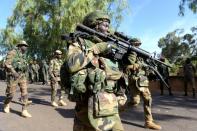 Soldiers from The Gambia and ECOWAS soldiers patrol in front of the Second Infantry Battalion Camp in Farafenni, Gambia on January 22, 2017