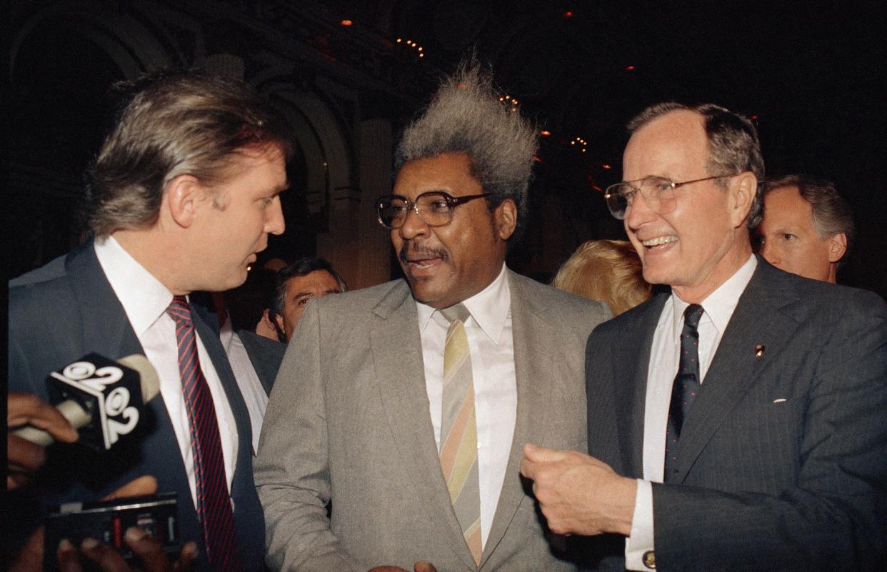 Vice President George Bush, right, shares a light moment with, from left, real estate developer and casino owner Donald Trump and fight promoter Don King, on April 12, 1988, at New York's Plaza Hotel during a fundraiser for Bush by Trump. Bush is in New York to campaign for next Tuesday's Republican presidential primary.