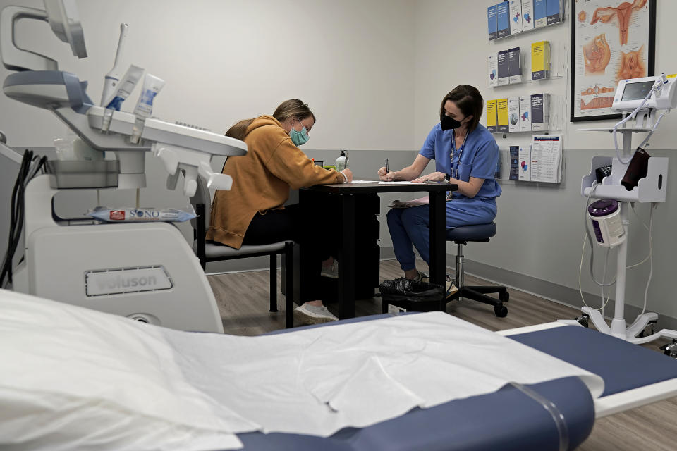 FILE - Dr. Elizabeth Brett Daily talks with patient Haley Ruark about the medical abortion process at a Planned Parenthood clinic, Oct. 12, 2022, in Kansas City, Kan. Comprehensive Health of Planned Parenthood Great Plains announced Tuesday, May 14, 2024, that Pittsburg, Kansas, will be home to a new facility providing abortion procedures and pills, as well as pregnancy services, contraception and testing and treatment for sexually transmitted diseases. (AP Photo/Charlie Riedel, File)