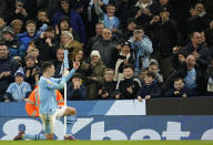Manchester City's Phil Foden gestures towards the fans after scoring his team's fourth goal during the English Premier League soccer match between Manchester City and Aston Villa at the Etihad Stadium in Manchester, England, Wednesday, April 3, 2024. (AP Photo/Dave Thompson)