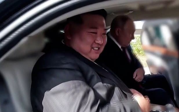 Kim Jong-un (L) and Russian President Vladimir Putin sit in Putin's presidential Aurus Senat limousine at Vostochny Cosmodrome in the Russian Far East in September 2023