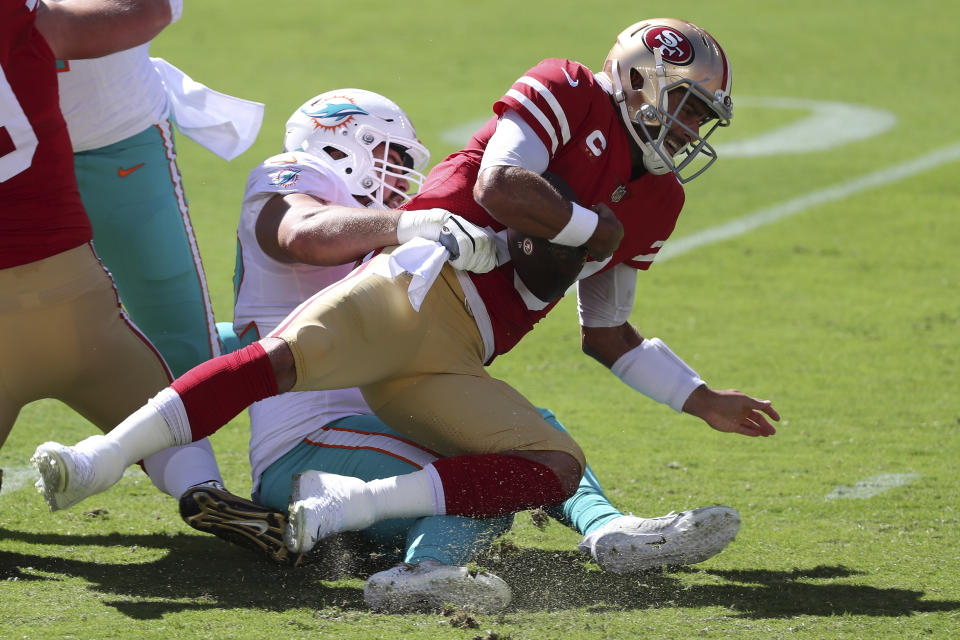 Miami Dolphins defensive end Zach Sieler, left, sacks San Francisco 49ers quarterback Jimmy Garoppolo during the first half of an NFL football game in Santa Clara, Calif., Sunday, Oct. 11, 2020. (AP Photo/Jed Jacobsohn)