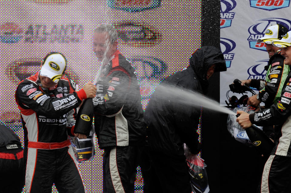 HAMPTON, GA - SEPTEMBER 06: Jeff Gordon, driver of the #24 Drive to End Hunger Chevrolet, celebrates with crew members in victory lane after winning the NASCAR Sprint Cup Series AdvoCare 500 at Atlanta Motor Speedway on September 6, 2011 in Hampton, Georgia. (Photo by John Harrelson/Getty Images for NASCAR)