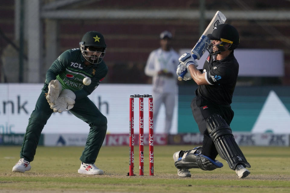 Pakistan's Mohammad Rizwan, left, takes the catch of New Zealand's Mark Chapman, right, during the fifth one-day international cricket match between New Zealand and Pakistan, in Karachi, Pakistan, Sunday, May 7, 2023. (AP Photo/Fareed Khan)