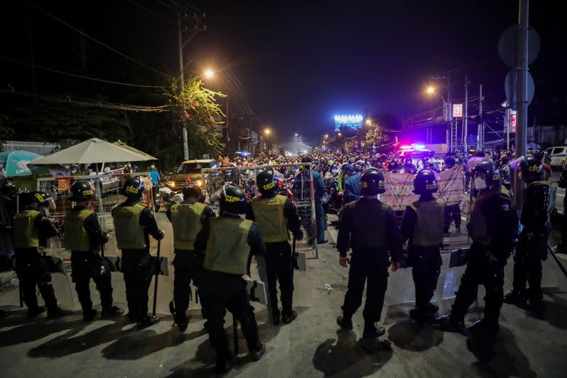 People planning to return to their hometowns wait at a checkpoint to leave Ho Chi Minh