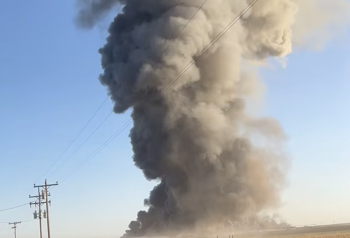 Smoke rises from the dairy farm after the fiery explosion (Silvia Martin / KFDA News Channel 10)