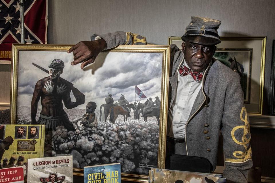 Artist and Confederate supporter Gregory Goodwin Newson at his booth in the vendors area of the Sons of Confederate Veterans national convention. Newson paints pictures of Black Confederate soldiers.