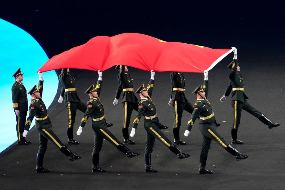 Soldiers carry the Chinese flag during the opening ceremony of the 2022 Winter Olympics, on Feb. 4, 2022, in Beijing.