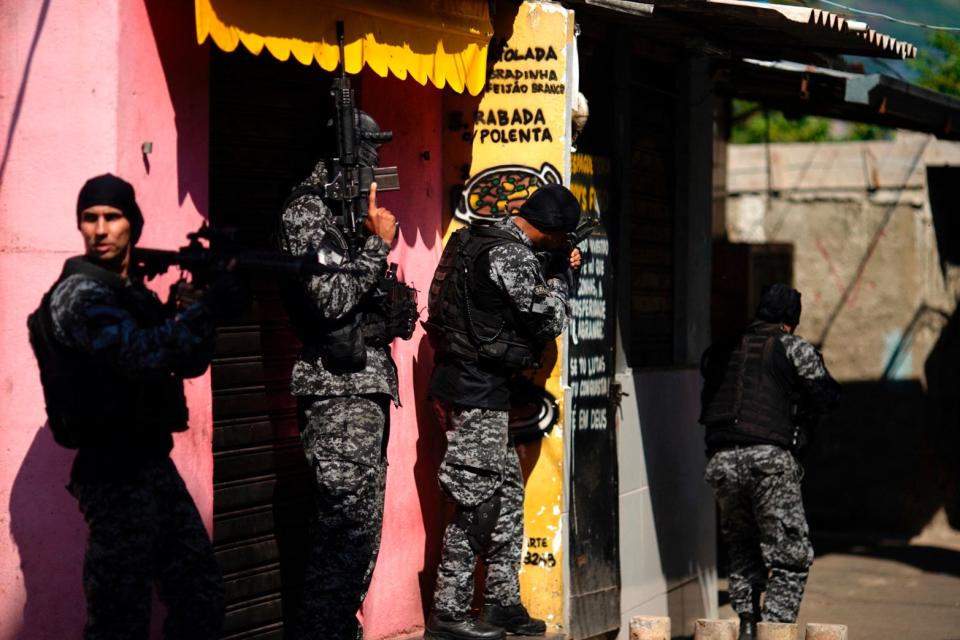 <p>Police officers carry out a raid against drug traffickers in the Jacarezinho area of Rio de Janeiro</p> (AFP via Getty Images)