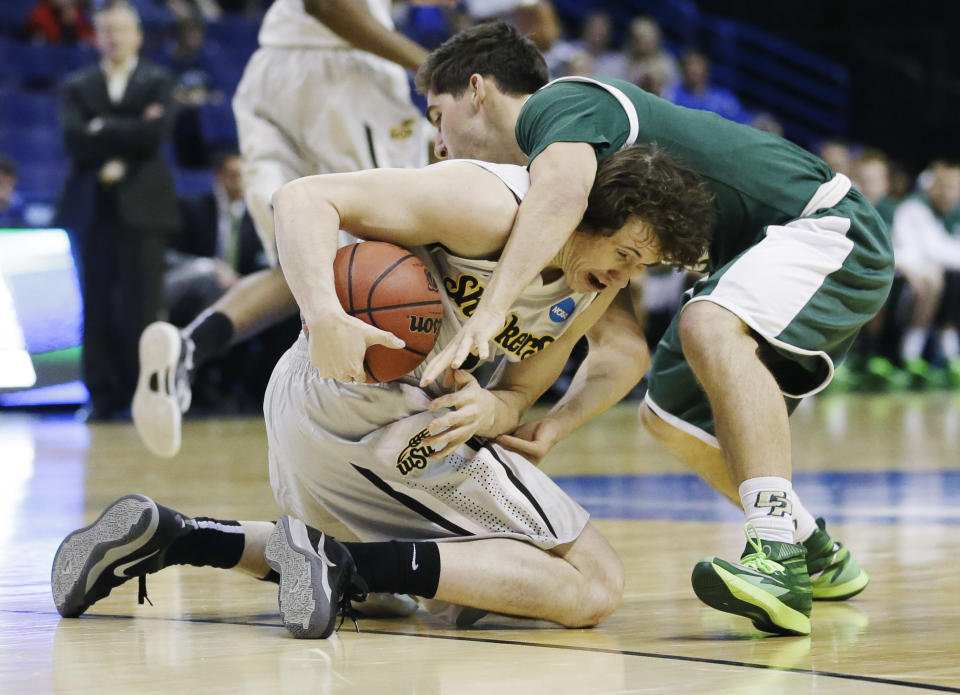 Wichita State guard Evan Wessel (3) and Cal Poly guard Ridge Shipley (10) go after the ball during the first half of a second-round game in the NCAA college basketball tournament Friday, March 21, 2014, in St. Louis. (AP Photo/Jeff Roberson)