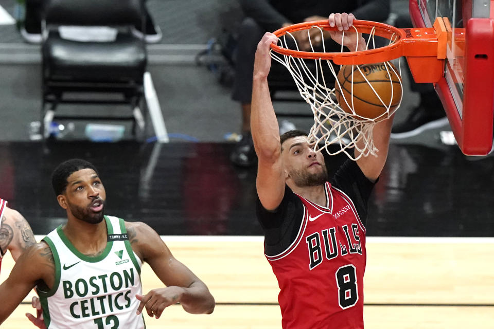Chicago Bulls guard Zach LaVine, right, dunks past Boston Celtics center Tristan Thompson during the second half of an NBA basketball game in Chicago, Friday, May 7, 2021. (AP Photo/Nam Y. Huh)