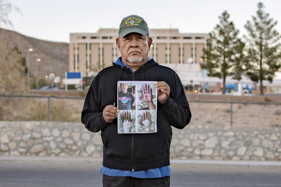 In this undated photo provided by the Institute for Justice, Vietnam veteran José Oliva holds a photo in front of the VA hospital in El Paso, Texas. (Institute for Justice via AP)