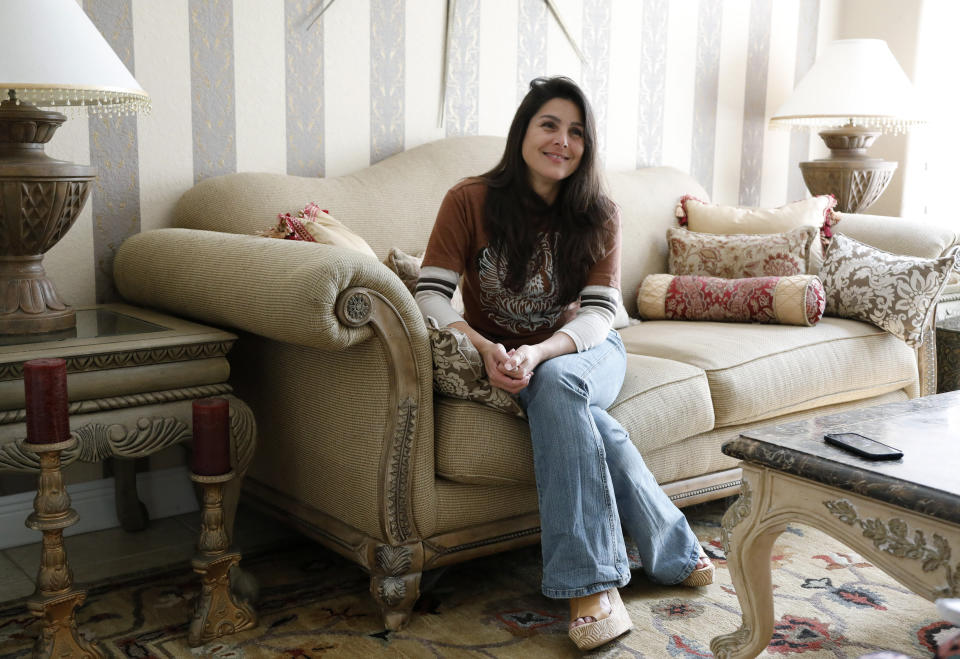 Judith Negron is interviewed at her home in Hialeah, Fla., Wednesday, Feb. 19, 2020. Negron was serving 35 years at a Florida prison for health care fraud, conspiracy and money laundering when she was released Tuesday after President Donald Trump commuted her sentence. (AP Photo/Terry Renna)