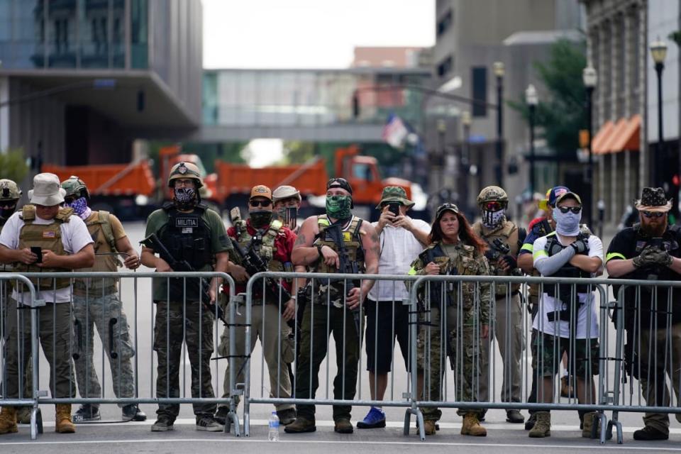 <div class="inline-image__caption"><p>Members of the Kentucky ‘Three Percenters’ militia line up as the all-Black militia group called NFAC hold an armed rally.</p></div> <div class="inline-image__credit">Bryan Woolston/Reuters</div>