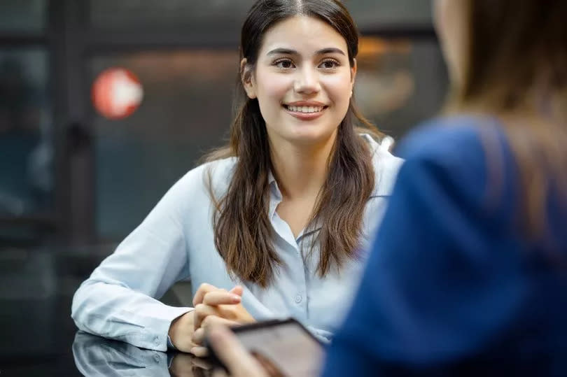 A woman on a job interview final round with an HR officer in an office