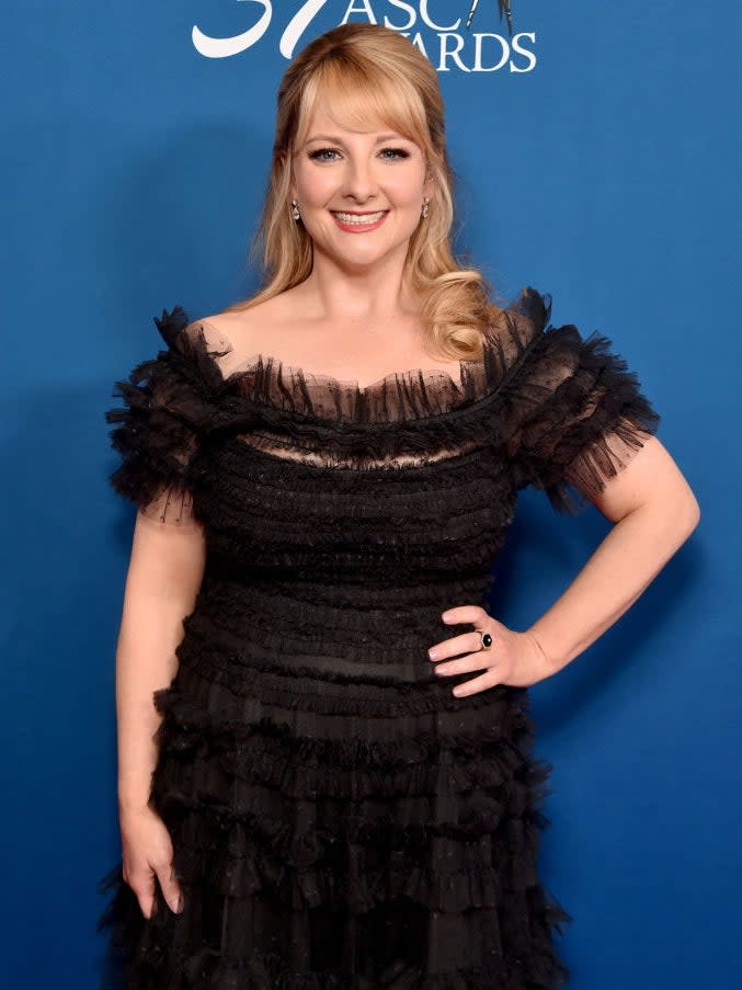 looking elegant in a black tulle dress with hair half up