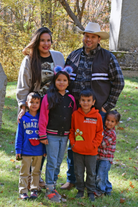 endawnis Spears stands for a family portrait with her children and husband, who is Narragansett, at a Narragansett tribal event. (Heather Mars)