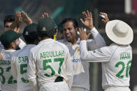 Pakistan's Nauman Ali, second right, celebrates with teammates after dismissal of New Zealand's Devon Conway during the third day of first test cricket match between Pakistan and New Zealand, in Karachi, Pakistan, Wednesday, Dec. 28, 2022. (AP Photo/Fareed Khan)
