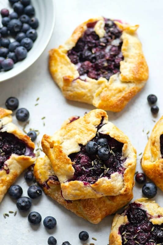 <p>Whole and Heavenly Oven</p><p>Fragrant lavender, creamy mascarpone, and juicy blueberries are a trio made in heaven in these mini blueberry galettes! They're perfectly mini-sized for a handheld summer dessert.</p><p><strong>Get the recipe: </strong><a href="https://wholeandheavenlyoven.com/2020/05/21/mini-lavender-mascarpone-blueberry-galettes/" rel="nofollow noopener" target="_blank" data-ylk="slk:Mini Lavender Mascarpone Blueberry Galettes;elm:context_link;itc:0;sec:content-canvas" class="link rapid-noclick-resp"><strong>Mini Lavender Mascarpone Blueberry Galettes</strong></a></p>