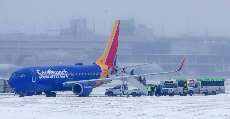 Passengers exit Southwest Airlines flight 1643 after the plane slid off the runway at Eppley Airfield Friday, Jan 18, 2019, in Omaha, Neb.